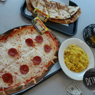 a pepperoni pizza and a side of rice