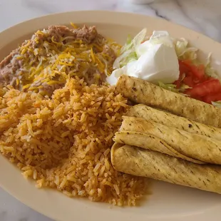 Stale and frozen taquitos with dry rice and tasteless beans