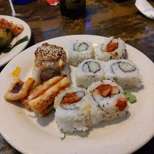 a plate of sushi and rolls