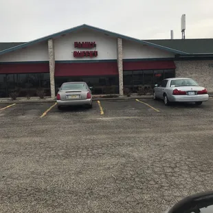 two cars parked in front of the restaurant