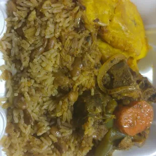 a styrofoam container with rice and vegetables