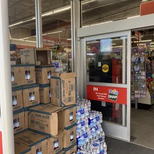 boxes of bottled water in front of a store