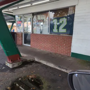 a broken gas pump on the side of the road