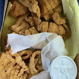 a basket of fried chicken and a cup of coffee