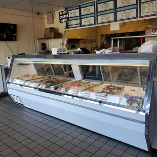 a man standing in front of a display of fish