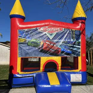 Deluxe castle bounce house with Cars banner