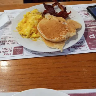 pancakes, eggs, bacon, and hash browns
