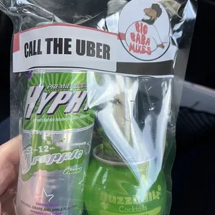 a hand holding a bottle of hand sanitizer and a bottle of hand sanitizer