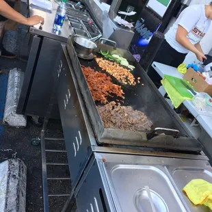 a man and woman preparing food
