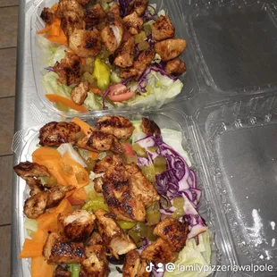 two trays of chicken and vegetables