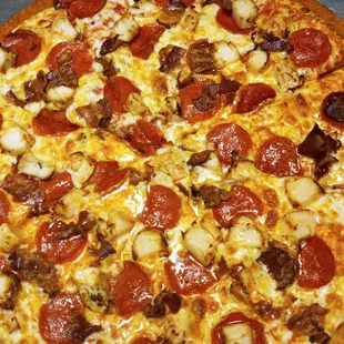 a pizza with pepperoni and sausage