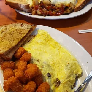 Philly omelet with tots and egg white veggie omelet with home fries.