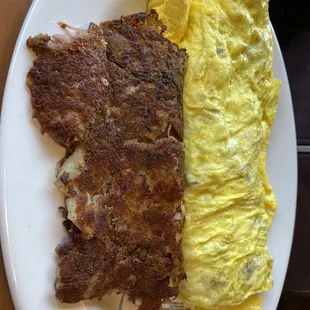 Steak and cheese omelette with a side of corn beef hash