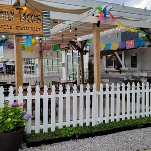 a white picketed fence and a white awning