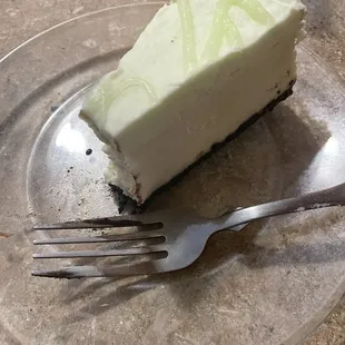 a slice of cheesecake on a plate with a fork