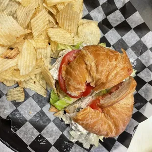 a croissant sandwich and chips