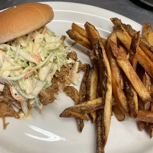 a pulled pork sandwich and french fries