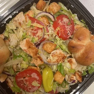 a salad in a styrofoam container