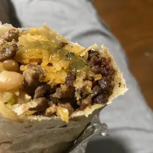 a person holding a burrito
