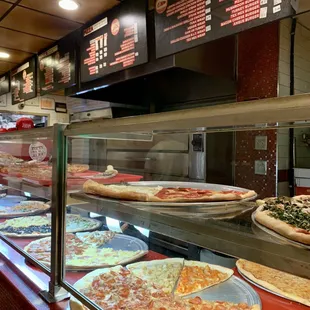 a variety of pizzas on display