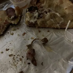 Pizza with sausage, chicken and extra staples.