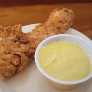 a plate of fried chicken and dipping sauce