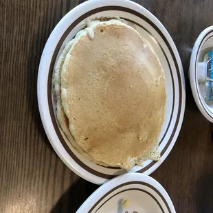 pancakes, eggs, bacon, and a cup of coffee