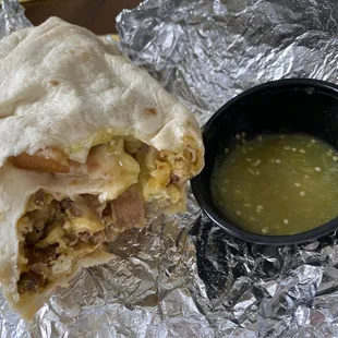 a burrito with a side of guacamole