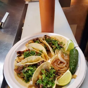 a plate of tacos and a drink