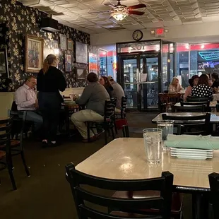 people sitting at tables in a restaurant