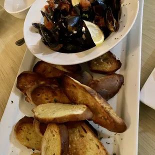 a plate of mussels and bread