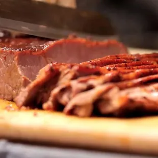 ows a sliced meat on a cutting board