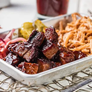 ows a tray of barbecued meat