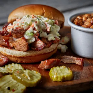ows a pulled pork sandwich with coleslaw and pickles