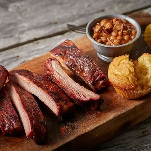 ribs and corn on a cutting board