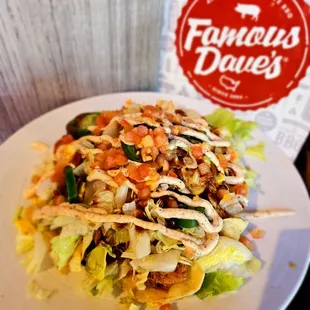 Famous Daves in Long Beach, Ca BBQ NACHOS, Crisp tortilla chips topped with cheddar cheese sauce, Dave&apos;s Award-Winning Chili...