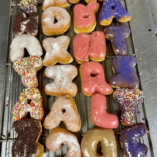 a variety of doughnuts on a cooling rack