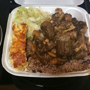 LG oxtails with cabbage and mac n cheese over rice and beans