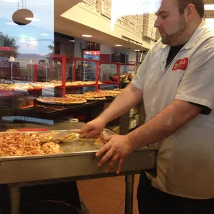 a man preparing a pizza