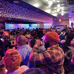 a crowd of people at a bar