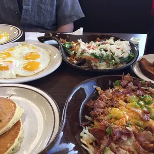a breakfast of pancakes, hash browns, and eggs