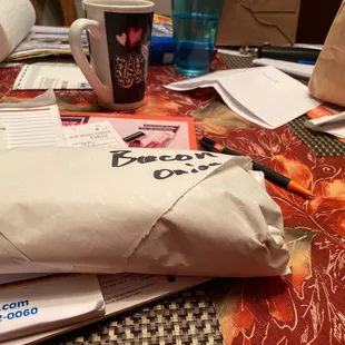 a sandwich wrapped in paper