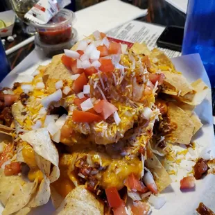 Big plate of Nachos. You can see the tiny packet of sour cream behind it though.