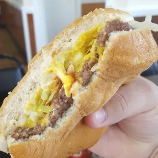 a hand holding a sub sandwich