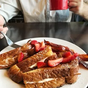 a plate of french toast with strawberries