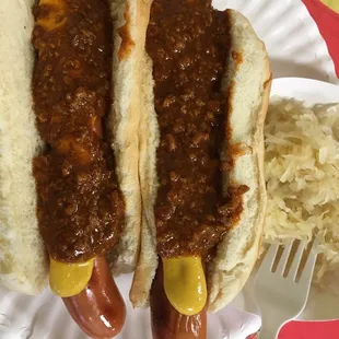 Hot Dogs with chili, mustard and sauerkraut on the side