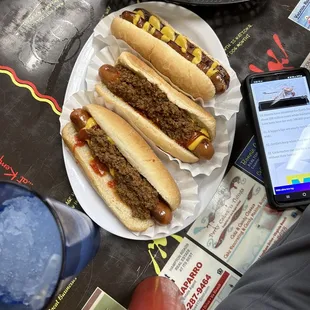 2 dogs with ketchup, mustard, and chili. One kielbasa with mustard.