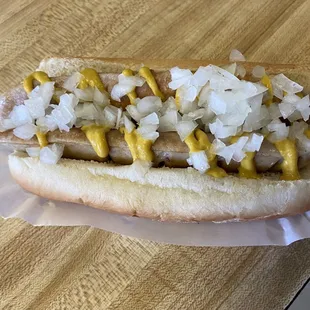 a hot dog with onions and mustard