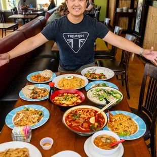 a man sitting at a table full of food
