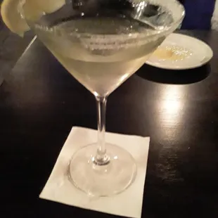 a martini with a slice of lemon on the rim